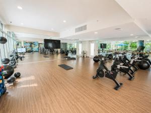 a gym with treadmills and exercise bikes in a room at Glendale Luxe Stays - Downtown in Glendale