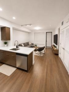 a kitchen and living room with a sink and a couch at Glendale Luxe Stays - Downtown in Glendale
