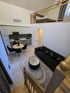 a living room with a couch and a table at A-frame-WHITE HOUSE-II in Qusar