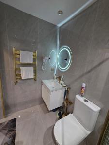 a bathroom with a toilet and a sink and a mirror at A-frame-WHITE HOUSE-II in Qusar +8 photos