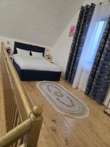 a bedroom with a bed and a large window at A-frame-WHITE HOUSE-II in Qusar