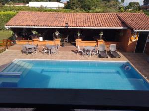 a large swimming pool with chairs and a house at Villa Isabel in La Tebaida +1 photo