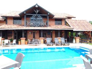 a house with a swimming pool in front of it at Villa Isabel in La Tebaida