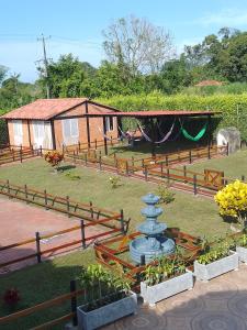 a building with a fence and a fountain in a yard at Villa Isabel in La Tebaida