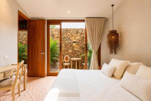 a bedroom with a bed and a table and a window at Las Dunas Beach house en Santa veronica cerca a la playa in Juan de Acosta +76 photos