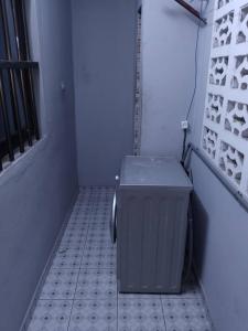 a trash can sitting on a tiled floor in a room at Le perchoir bleu in Lomé +33 photos
