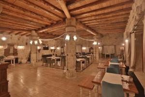 a large room with tables and chairs in a building at Acropolis Cave Suite in Ürgüp