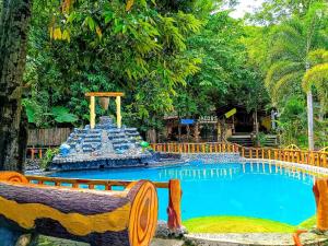 a fountain in the middle of a swimming pool at Jacob's Well Resort in Rizal