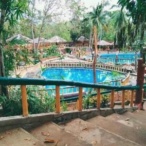 a large swimming pool in a resort with a resort at Jacob's Well Resort in Rizal