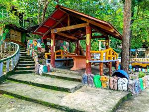 a playground with a wooden pavilion in a park at Jacob's Well Resort in Rizal