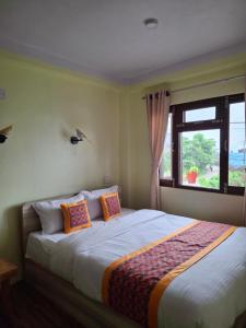 a bedroom with a large bed with a window at Mountain View Homestay in Tānsen