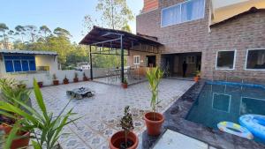 a backyard of a house with a swimming pool at Grandwood Coco Resort Yercaud in Yercaud +41 photos