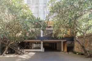 a building with trees in front of it at RedDoorz near Gubeng Station Surabaya in Bagongpatar