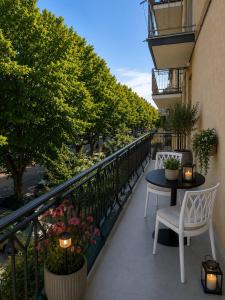 a balcony with a table and chairs and trees at Cozy apartment overlooking the main square in Orsogna
