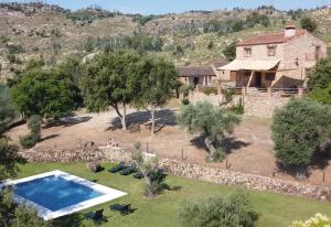 an aerial view of a house with a swimming pool at Detached 4 Bedroom Villa with Pool in Valencia de Alcántara