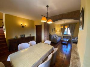 a living room with a table and chairs and a couch at Detached 4 Bedroom Villa with Pool in Valencia de Alcántara
