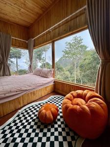 a room with two large ottomans in front of a window at Dốc Mơ Homestay in Bản Bé