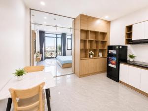 a kitchen and living room with a table and a refrigerator at Samaki Home in Ho Chi Minh City +9 photos