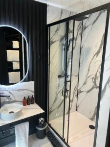 a bathroom with a marble shower and a sink at Bromielaw Room Only Accommodation in Seahouses +33 photos