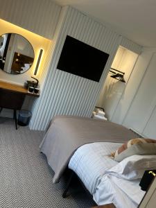 a bedroom with a bed and a desk and a mirror at Bromielaw Room Only Accommodation in Seahouses