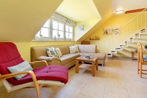 a living room with a couch and a table at Seehaus in Bojendorf
