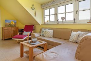 a living room with a couch and a table at Seehaus in Bojendorf