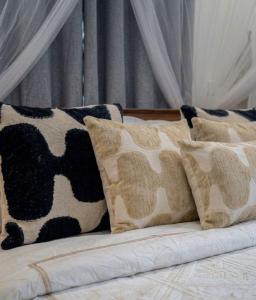 a couch with cow pillows on top of it at Sunset tiny house near fisherman village in Bophut