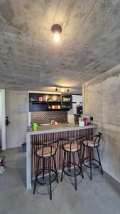 a kitchen with a bar with stools around it at Loft type apartment premium style with pool in Barranquilla