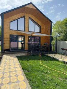 a tiny house on a lawn with a backyard at The Barn in Cholpon-Ata