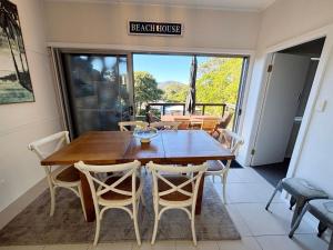 a dining room with a wooden table and chairs at Our Place in South West Rocks