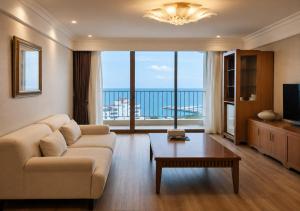 a living room with a couch and a table at Hotel Maremons in Sokcho