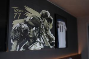 a painting of two baseball players on a wall at tower eleven hotel in Kitahiroshima