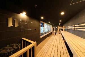 a row of benches in a building with lights at tower eleven hotel in Kitahiroshima