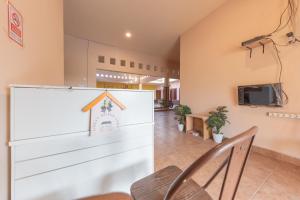 a meeting room with a table and chairs and a tv at Urbanview Hotel Sany Cirebon in Tangkil