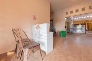 a chair sitting in a room with a counter at Urbanview Hotel Sany Cirebon in Tangkil +24 photos
