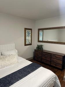 a bedroom with a bed and a large mirror at Alki Beach Nest in Seattle