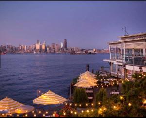 a group of umbrellas and a building next to the water at Alki Beach Nest in Seattle