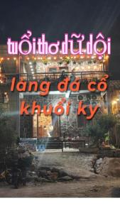 a lit up sign for a building at night at A thám homesstay in Dam Thuy +3 photos