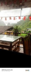 a table and chairs with a view of a mountain at A thám homesstay in Dam Thuy