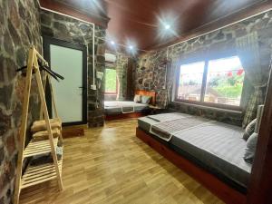 a bedroom with a bed in a room with rocks at A thám homesstay in Dam Thuy