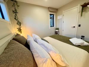 two beds sitting next to each other in a room at Modern Mountain Retreat in Ohakune