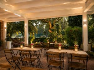 a patio with tables and chairs with lights at Residence MareVerde in Senigallia