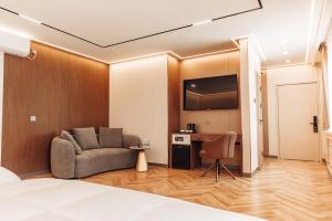 a hotel room with a couch and a table at Sansar Hotel Erdenet in Erdenet