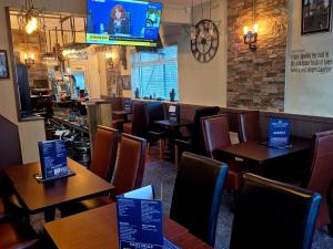 a restaurant with tables and chairs and a bar at Miners Lamp Apartment in Easington +15 photos