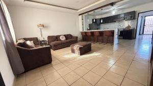 a living room with two couches and a bar at Casa Ari in Lázaro Cárdenas +11 photos