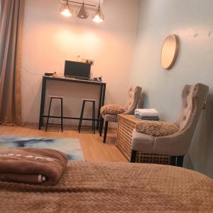 a bedroom with a desk and two chairs and a table at Sekebun Bunga in Tumpat