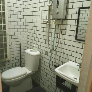 a bathroom with a toilet and a sink at Sekebun Bunga in Tumpat