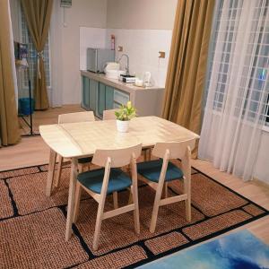 a wooden table and chairs in a kitchen at Sekebun Bunga in Tumpat