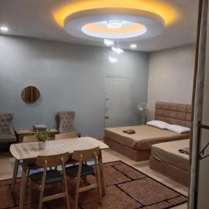 a bedroom with a bed and a table and chairs at Sekebun Bunga in Tumpat +6 photos