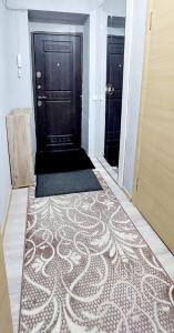 a hallway with a door and a carpet on the floor at ЖК Куралай in Qyzylorda